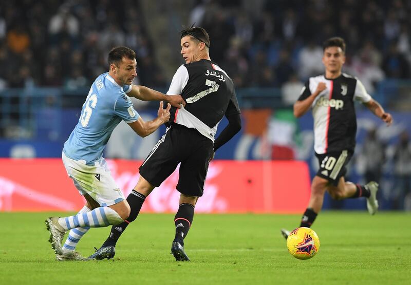 Juventus' Cristiano Ronaldo in action with Lazio's Stefan Radu. Reuters