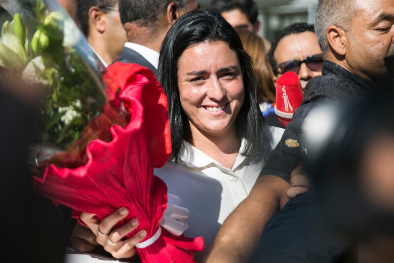 Tunisian tennis player Ons Jabeur holds a bouquet as she arrives in Tunis. Jabeur recently lost against Kazakhstan's Elena Rybakina in the women's singles final of the Wimbledon tennis championships in London. AP