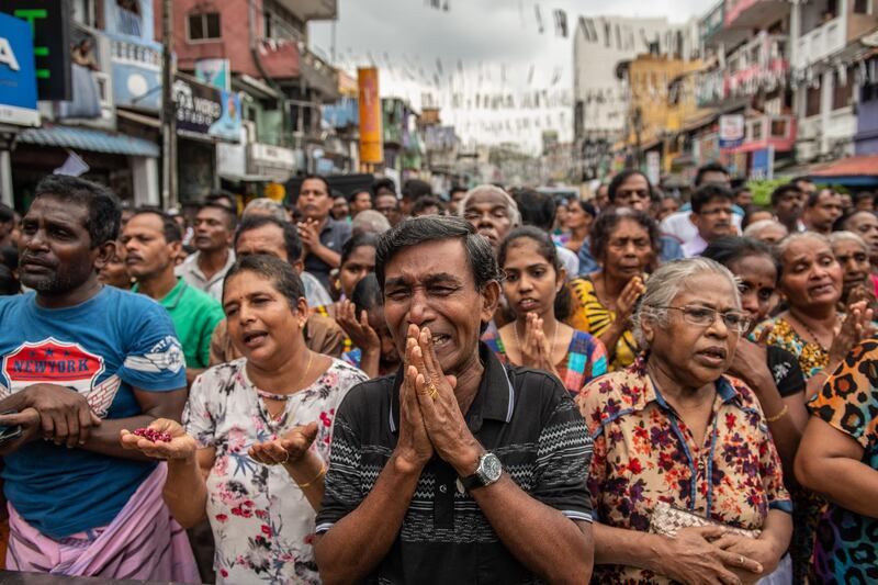 COLOMBO, SRI LANKA - APRIL 28: Sri Lankans pray in the street near St Anthony's Shrine one week on from the attacks that killed over 250 people, on April 28, 2019 in Colombo, Sri Lanka. At least 15 people, including six children, were found dead on Saturday morning in the village of Bolivarian on Sri Lanka's east coast after a raid by security forces on a house linked to the Easter suicide bombings. Based on reports, the Islamic State group claimed responsibility for the attacks late on Friday as the hunt for accomplices goes on in eastern Sri Lanka. More than 253 people were killed on Easter Sunday after coordinated terror attacks on three churches and three luxury hotels in the Colombo area and eastern city of Batticaloa, injuring hundreds. (Photo by Carl Court/Getty Images)