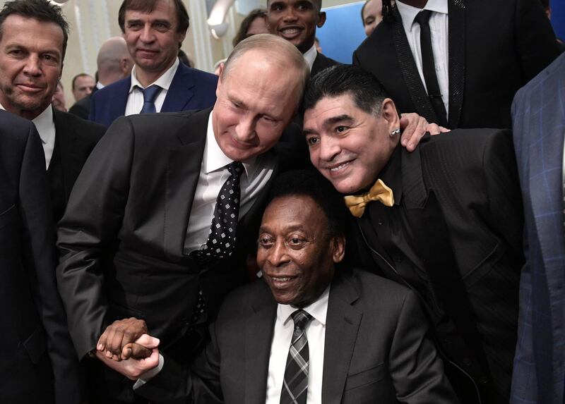 Russian president Vladimir Putin, Brazilian football legend Pele and Argentina's Diego Maradona pose for pictures ahead of the Final Draw for the 2018 FIFA World Cup football tournament at the State Kremlin Palace in Moscow. Alexey Nikolsky / AFP