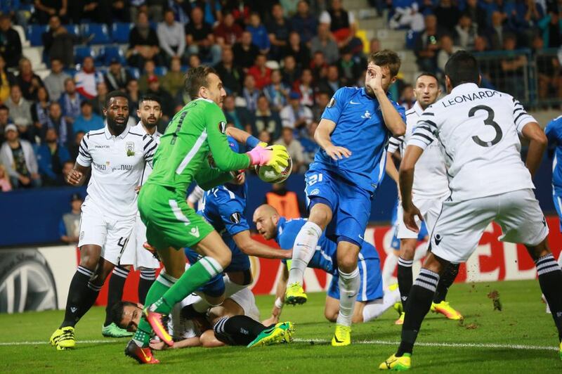 Liberec’s Nikolai Komlichenko, in blue, is denied by PAOK’s goalkeeper Panagiotis Glykos. AFP / RADEK MICA