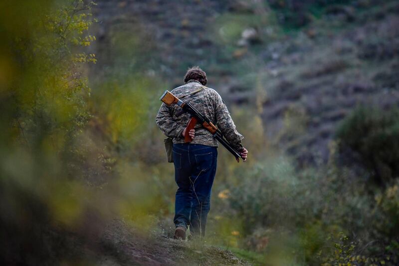 A volunteer fighter walks in a valley outside a village south-east of Stepanakert. AFP