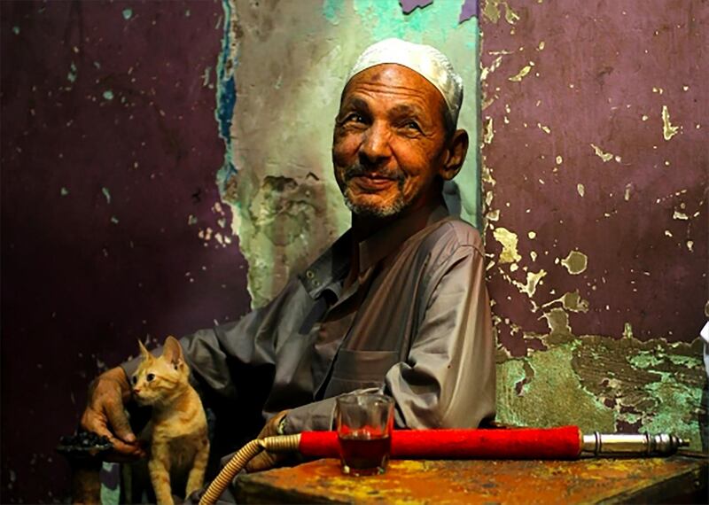 Photo by Nouni Azo of a man enjoying tea and shisha after breakfast at a coffee shop in Cairo, Egypt. Courtesy National Geographic Abu Dhabi