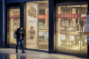 A woman passes a closed shop on the main shopping street in central Frankfurt, Germany, whose economy grew by a meagre 0.1% in the fourth quarter of 2020. AP