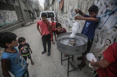 epa06991149 Palestinians refugees making candy floss in the Shateaa refugee camp in the north west Gaza City, 01 September 2018. According to media reports on 31 August 2018, the United States has ended all funding to the United Nations Relief and Works Agency for Palestine Refugees in the Near East (UNRWA). 'The administration has carefully reviewed the issue and determined that the United States will not make additional contributions to UNRWA' according to a statement by the US State Department.  EPA/HAITHAM IMAD