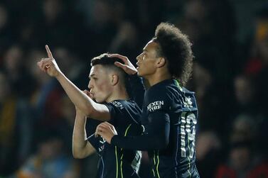 Manchester City's Phil Foden, left, celebrates with his teammate Leroy Sane after scoring his side's third goal during the English FA Cup fifth round soccer match between Newport County and Manchester City at Rodney Parade stadium in Newport, Wales, Saturday, Feb. 16, 2019. (AP Photo/Frank Augstein)