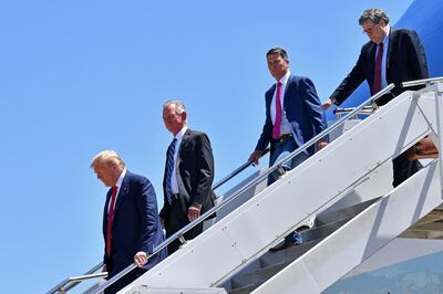 (FILES) In this file photo US President Donald Trump steps off Air Force One, alongside US Attorney General William Barr (R), Ronny Jackson (2nd R), Candidate for United States Representative for Texas's 13th Congressional District, and Tommy Tuberville (2nd L)Candidate for United States Senate from Alabama, upon arrival in Dallas, Texas, on June 11, 2020, where he will host a roundtable with faith leaders and small business owners.  Former US Attorney General Jeff Sessions on July 14, 2020, lost the Republican nomination for his old Senate seat in Alabama to former college football coach Tommy Tuberville, likely ending a long political career with a bitter defeat egged on by President Donald Trump.  / AFP / Nicholas Kamm
