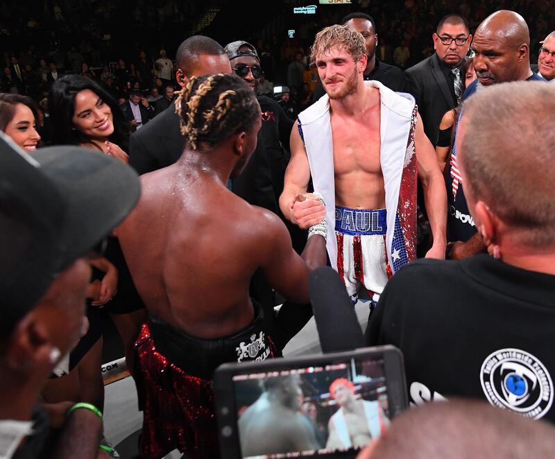 KSI (black/red shorts) and Logan Paul (red/white/blue shorts) shake hands in the ring. AFP
