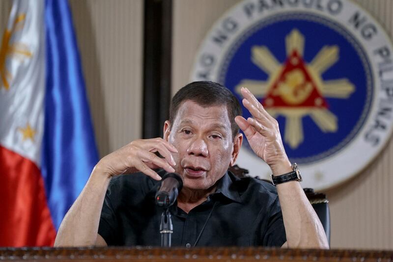 In this March 30, 2020, photo provided by the Malacanang Presidential Photographers Division, Philippine President Rodrigo Duterte gestures as he addresses the nation during a live broadcast in Malacanang, Manila, Philippines. Duterte is on quarantine for more than a week after meeting officials who have been exposed to people infected with the coronavirus. The new coronavirus causes mild or moderate symptoms for most people, but for some, especially older adults and people with existing health problems, it can cause more severe illness or death. (King Rodriguez, Malacanang Presidential Photographers Division via AP)