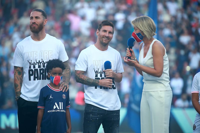 Paris Saint-Germain's new recruits Lionel Messi and Sergio Ramos greet their fans during their presentation at the half-time of the French Ligue 1 soccer match between Paris Saint Germain and Strasbourg at the Parc des Princes stadium in Paris, France.