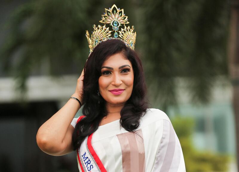 Pushpika De Silva poses for photographs with her Mrs Sri Lanka crown after it was forcibly removed by Mrs World, Caroline Jurie at the Mrs Sri Lanka contest, in Colombo. Reuters