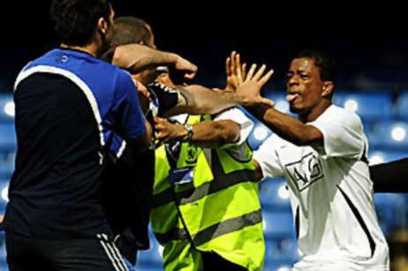 Patrice Evra, right, fights with Chelsea ground staff in April.
