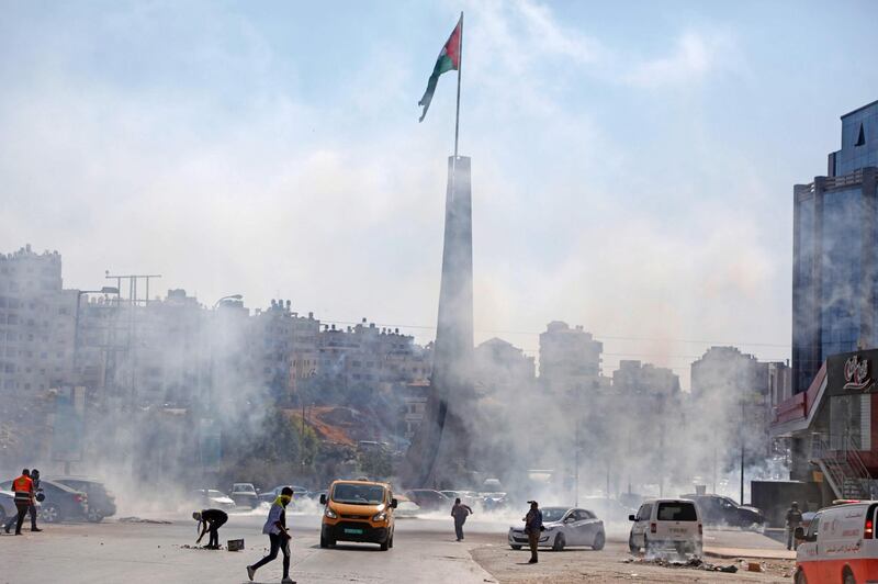 Tear gas fumes erupt at the scene of clashes between Palestinian protesters and Israeli security forces at the entrance of the West Bank city of Ramallah close to the Jewish settlement of Beit El. AFP