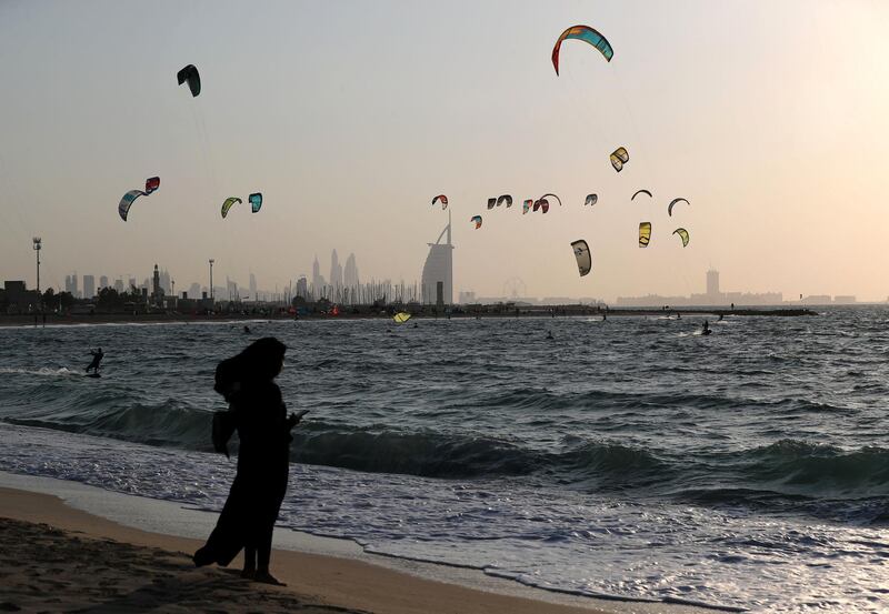 Dubai, United Arab Emirates - December 11, 2018: Dozens of kite suffers head to the beach to enjoy the wide conditions. Tuesday the 11th of December 2018 at Jumeirah Beach, Dubai. Chris Whiteoak / The National