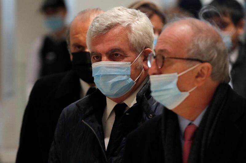 French lawyer Thierry Herzog, wearing a protective face mask, arrives with his lawyers Paul-Albert Iweins and Herve Temime, for the verdict in his trial on charges of corruption and influence peddling, at Paris courthouse. Reuters