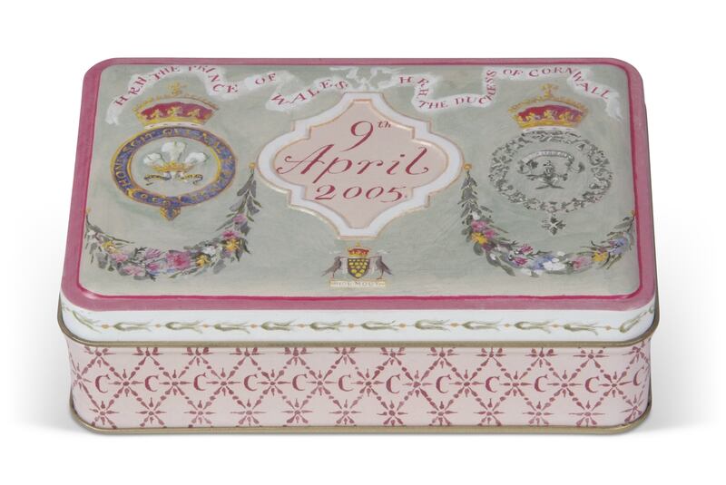 A souvenir tin that contains a 17-year-old slice of wedding cake from the marriage of King Charles III and Queen Consort Camilla. PA