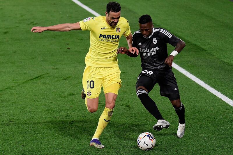 Villarreal's midfielder Vicente Iborra, left, challenges Real Madrid's Vinicius Junior. AFP