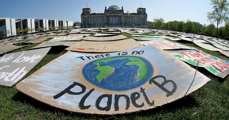 Signs from Fridays for Future movement in Berlin, Germany. Ten cities joined New York and London in committing to divest from fossil fuel companies as part of efforts to combat climate change. AP