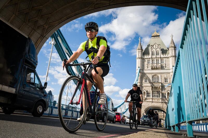 LONDON, ENGLAND - JULY 28: Cyclists ride across Tower Bridge during the evening rush hour on July 28, 2020 in London, England. Prime Minister Boris Johnson has announced a series of schemes aimed at promoting healthier living and cycling, including bicycle repair vouchers to encourage people to return to their bikes. (Photo by Leon Neal/Getty Images)