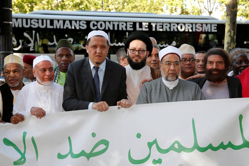 Jewish French writer Marek Halter (right) and Imam Hassen Chalghoumi (third left) are pictured with other Muslim leaders at the start of a European tour to the sites of recent Islamist attacks, on the Champs-Elysees in Paris on July 8, 2017. Pascal Rossignol / Reuters