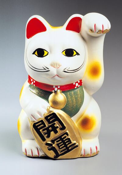 JAPAN - OCTOBER 13: Maneki neko, cat-shaped porcelain sculpture, a common Japanese talisman. Japan, 20th century. (Photo by DeAgostini/Getty Images)