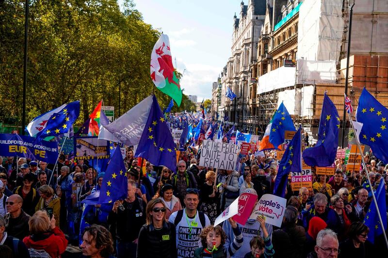 Demonstrators hold placards and EU and Union flags as they take part in a march by the People's Vote organisation in central London on October 19, 2019, calling for a final say in a second referendum on Brexit. Thousands of people march to parliament calling for a "People's Vote", with an option to reverse Brexit as MPs hold a debate on Prime Minister Boris Johnson's Brexit deal. / AFP / Niklas HALLE'N
