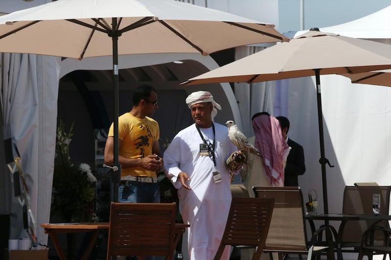 A participant holds a falcon at the Abu Dhabi Air Expo at Al Bateen airport. Fatima Al Marzooqi / The National