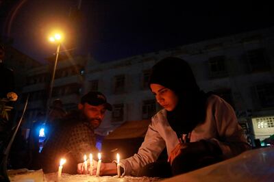 People light candles for slain protesters in Tahrir Square, in Baghdad, Iraq, Monday, Nov. 18, 2019. (AP Photo/Khalid Mohammed)