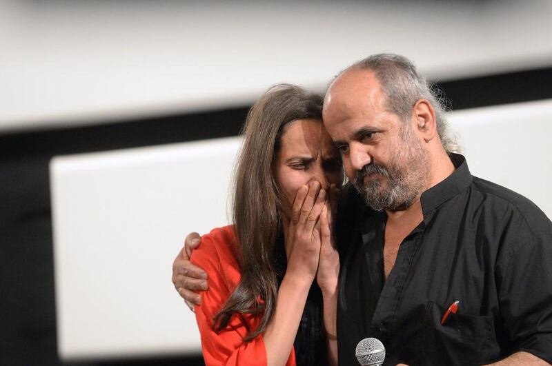 Ossama Mohammed comforts Wiam Simav Bedirxan, whose footage of the siege of the Syrian city of Homs inspired him to make “Silvered Water, Syria Self-Portrait” before the film’s screening at the Cannes Film Festival. AFP

