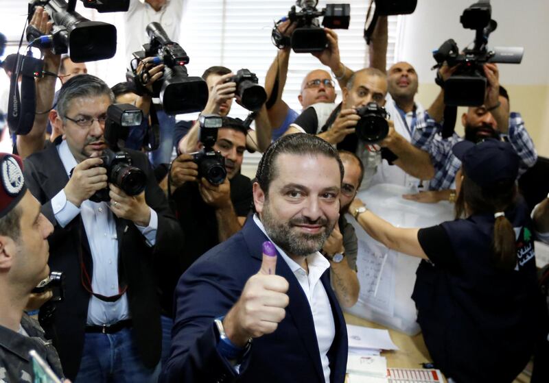 Lebanese prime minister and candidate for the parliamentary election Saad al-Hariri shows his ink-stained finger after casting his vote in Beirut, Lebanon, May 6, 2018. REUTERS/Jamal Saidi