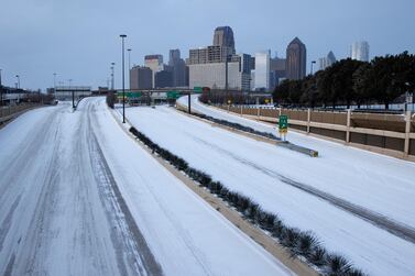 Snow covers downtown Dallas after rare blizzards hit Texas this week. Climate scientists warned of the urgency to reach zero carbon emissions. AP