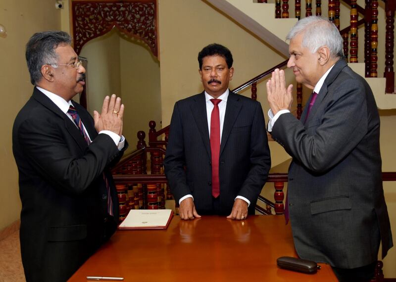 Sri Lankan Prime Minister Ranil Wickremesinghe, right, is sworn in as acting president by Chief Justice Jayantha Jayasuriya in Colombo. EPA