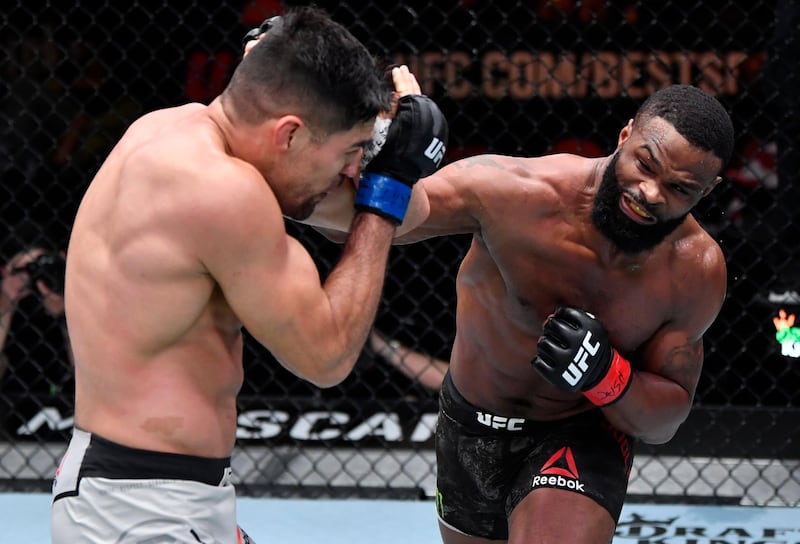 Tyron Woodley punches Vicente Luque in their welterweight fight during the UFC 260 event at UFC APEX in Las Vegas, Nevada. Jeff Bottari / USA TODAY Sports / Reuters