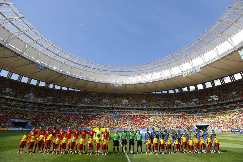 The national football teams of Switzerland, left, and Ecuador, right, pose on Sunday before their 2014 World Cup Group E match in Brasilia, Brazil. Robert Ghement / EPA