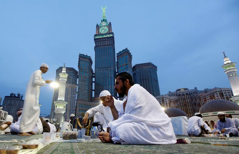 Worshippers eat during Iftar, or breaking of the fast, at the Grand Mosque in the holy Muslim city of Mecca, Saudi Arabia, Wednesday, July 10, 2013. Many devout Muslims in the Middle East have started observing the dawn-to-dusk fast for the month of Ramadan even as the region is rocked by Egypt's turmoil and the relentless civil war in Syria. For most Sunnis and Shiites, Ramadan started on Wednesday while others are expected to begin observing the holy month on Thursday differences based on various sightings of the new moon. (AP Photo/Hadi Mizban) *** Local Caption ***  Mideast Saudi Arabia Ramadan .JPEG-043dc.jpg