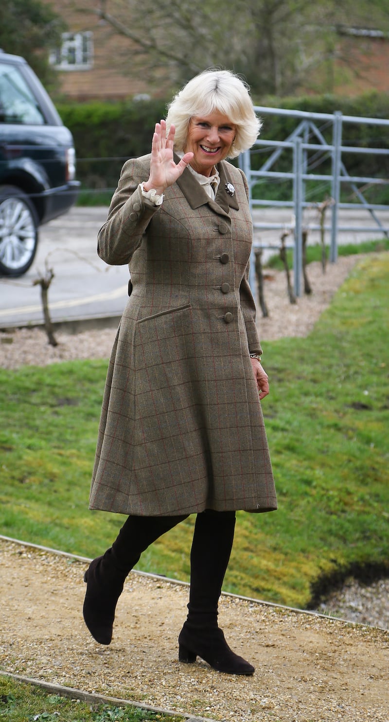 The queen consort wearing a tweed coat and black boots for an official visit to the new Wine Research Centre at Plumpton College on March 26, 2014. Getty Images