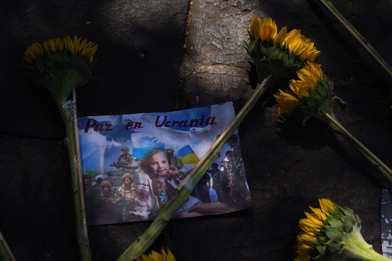 Sunflowers and an image with a message in Spanish that reads 'Peace in Ukraine' placed outside the Russian embassy in Mexico City by demonstrators during a protest against Moscow's invasion of Ukraine. AP
