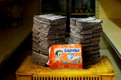 A package of diapers is pictured next to 8,000,000 bolivars, its price and the equivalent of 1.22 USD, at a mini-market in Caracas, Venezuela August 16, 2018. It was the going price at an informal market in the low-income neighborhood of Catia. REUTERS/Carlos Garcia Rawlins   SEARCH "GARCIA ECONOMY" FOR THIS STORY. SEARCH "WIDER IMAGE" FOR ALL STORIES.