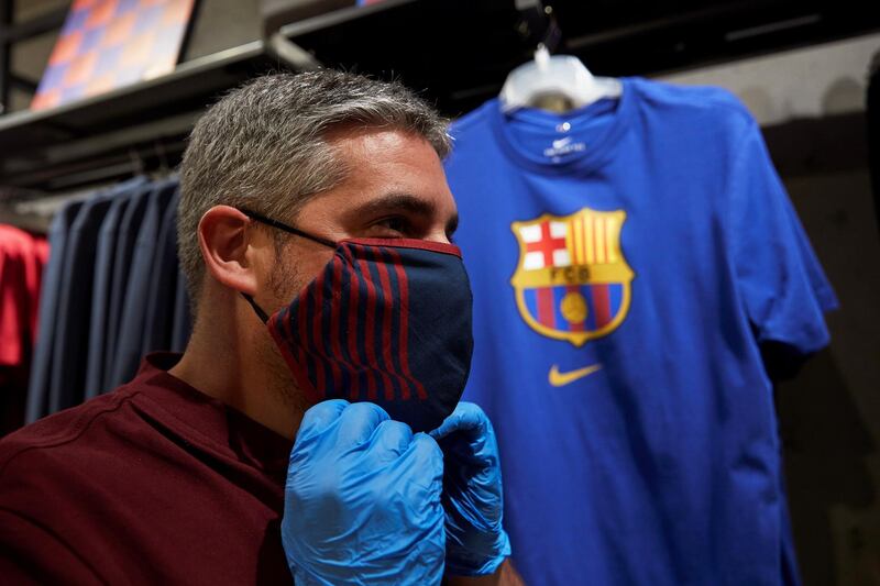 A man wearing a protective face mask poses during the presentation of official FC Barcelona brand masks. EPA