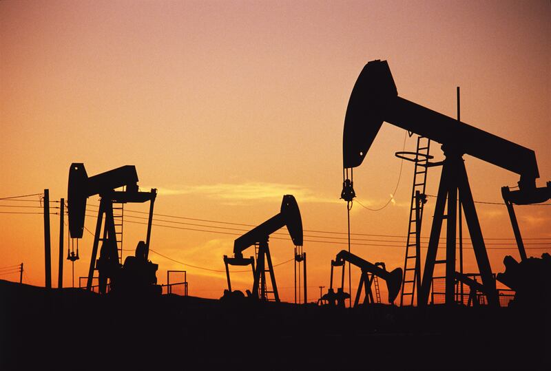 May, 1990, Kern County, California, USA --- Oil Pumping Units at Sunset --- Image by © Lowell Georgia/Corbis