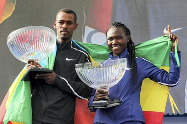 Dubai, United Arab Emirates - January 25, 2019: Winner of the womens race Ruth Chepngetich with Getaneh Tamire Molla winner of the mens race at the Standard Chartered Dubai Marathon 2019. Friday, January 25th, 2019 at Jumeirah, Dubai. Chris Whiteoak/The National