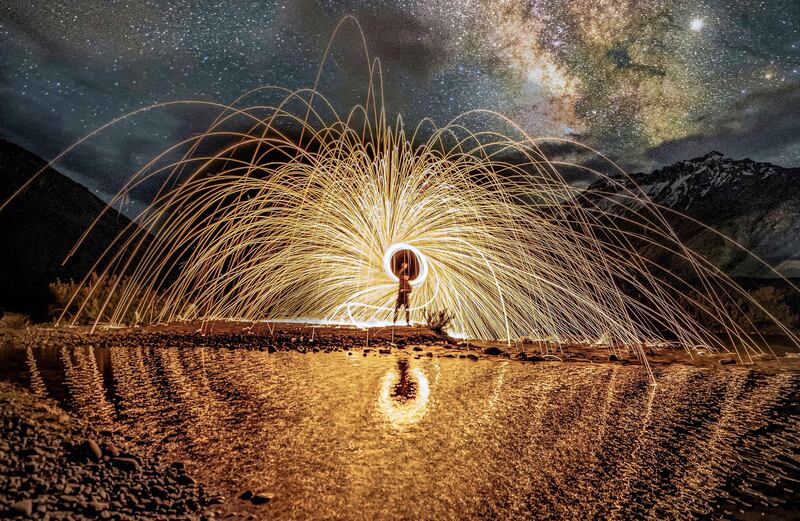 Sparks fly in front of the Milky Way. Ganesh Bagal 
 / Shutterstock