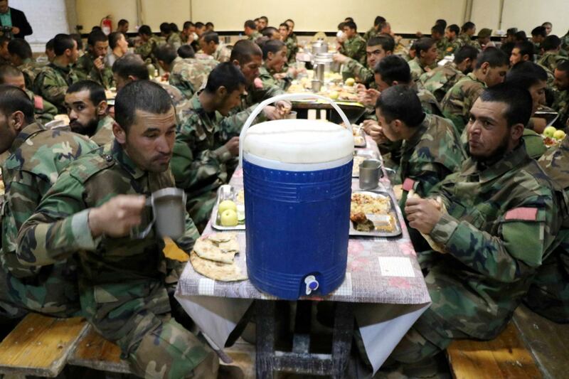 Food and water for troops of the Afghan National Army as they break the Ramadan fast at their base in Herat, western Afghanistan. EPA