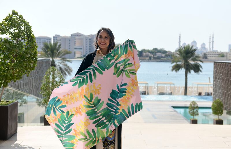 The businesswoman displays one of her eye-catching beach towels



