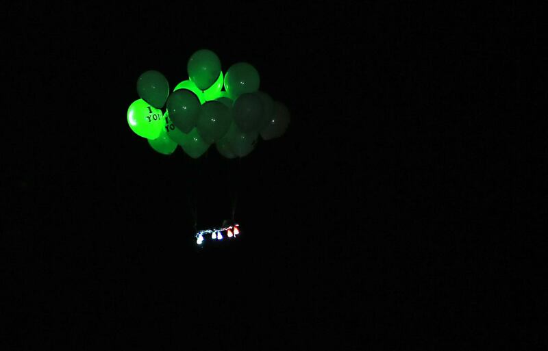 Ballons attached with flammable materials launched by Palestinian protesters calling themselves the "night confusion units" fly towards Israel, near the Gaza-Israel border east of Rafah in the southern Gaza Strip, on September 26, 2018. The border protests since March 30 have been labelled the "Great March of Return" because they call for Palestinian refugees to return to their former homes inside what is now Israel. Hundreds of thousands of dollars in damage were caused to Israeli land -- including incinerated crops -- by the kites and balloons, Israeli authorities said. / AFP / SAID KHATIB
