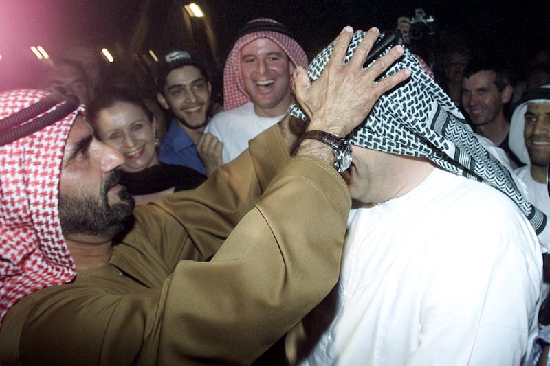 Sheikh Mohammed bin Rashid jokes with Kentucky breeder Allan Lavin, wearing a kefiyeh, during an event ahead of the 2001 Dubai World Cup. Reuters