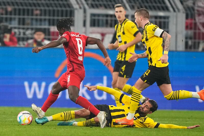 Leipzig's Amadou Haidara, left, challenges for the ball with Dortmund's Emre Can. AP Photo 