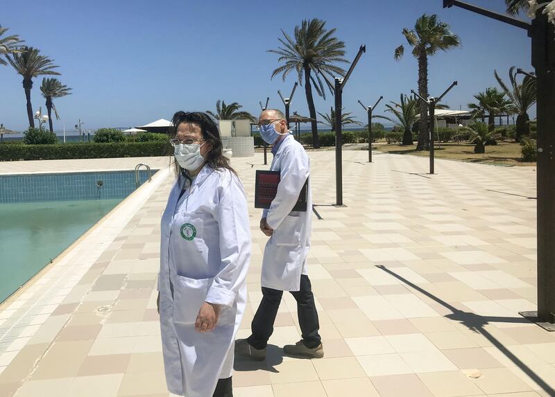 Dr Samir Lahouel (right), a health director for the region, inspects the facilities of a hotel in the Tunisian city of Mahdia housing Tunisians who are under compulsory quarantine following their repatriation.   AFP