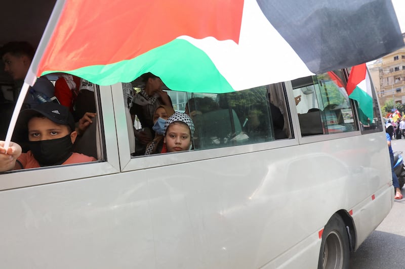 Children on a bus at Shatila refugee camp. AFP