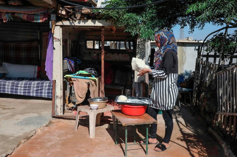 A woman kneads dough to make bread in Al Issifer Palestinian village south of Yatta town, in the occupied West Bank. AFP
